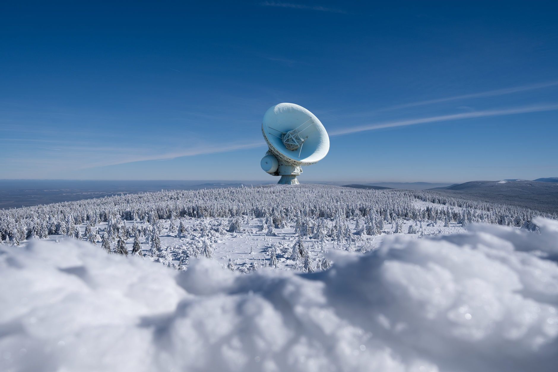 A satellite dish in deep snow illustrating how to protect Starlink equipment in extreme weather.