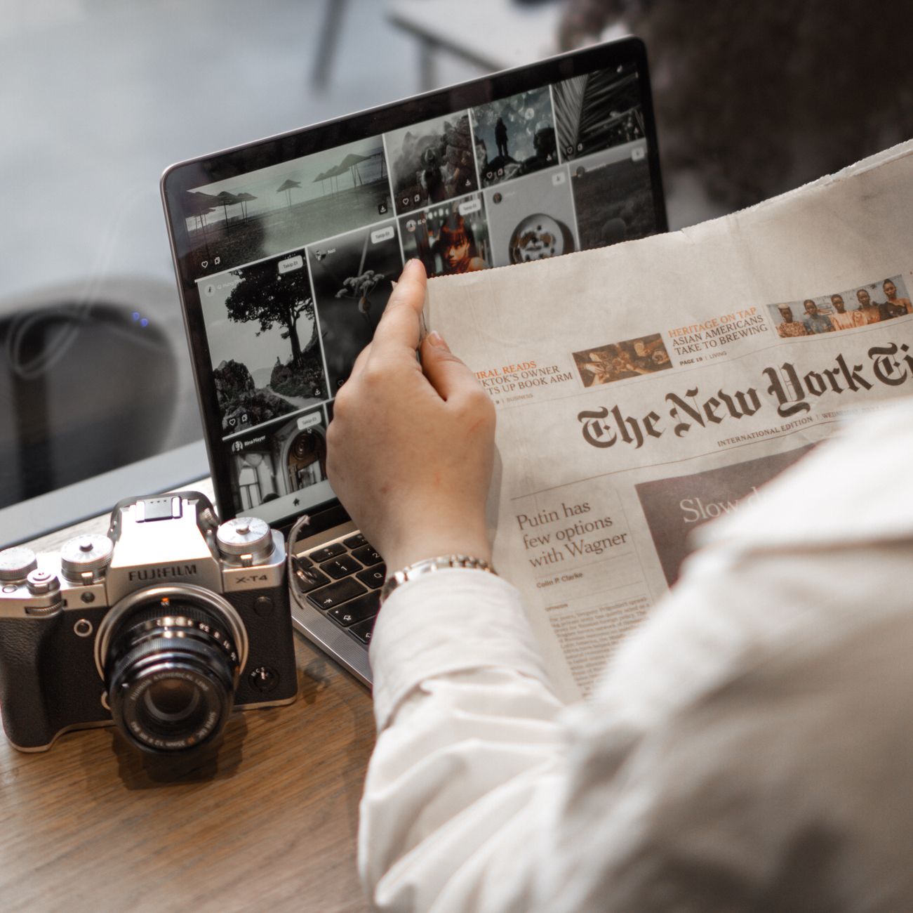 Reading technology news beside a laptop
