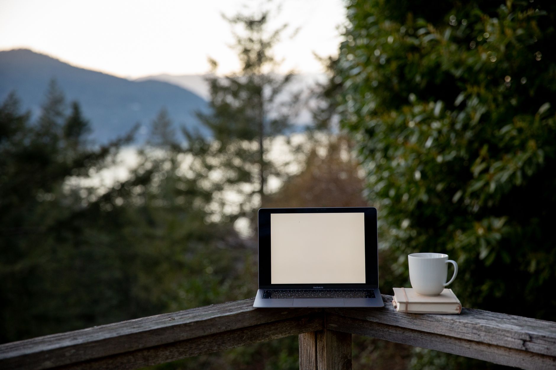 Laptop workspace with a countryside view
