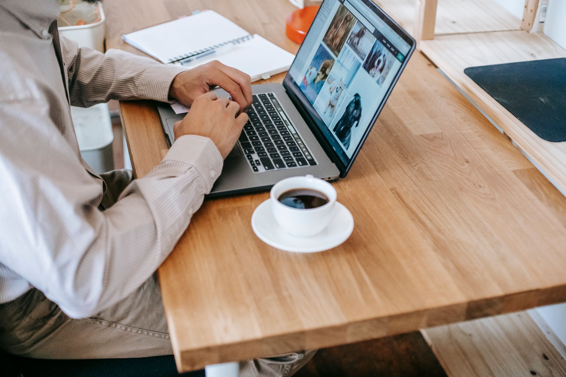 Person working on a laptop at a home-office desk while testing an internet upload
