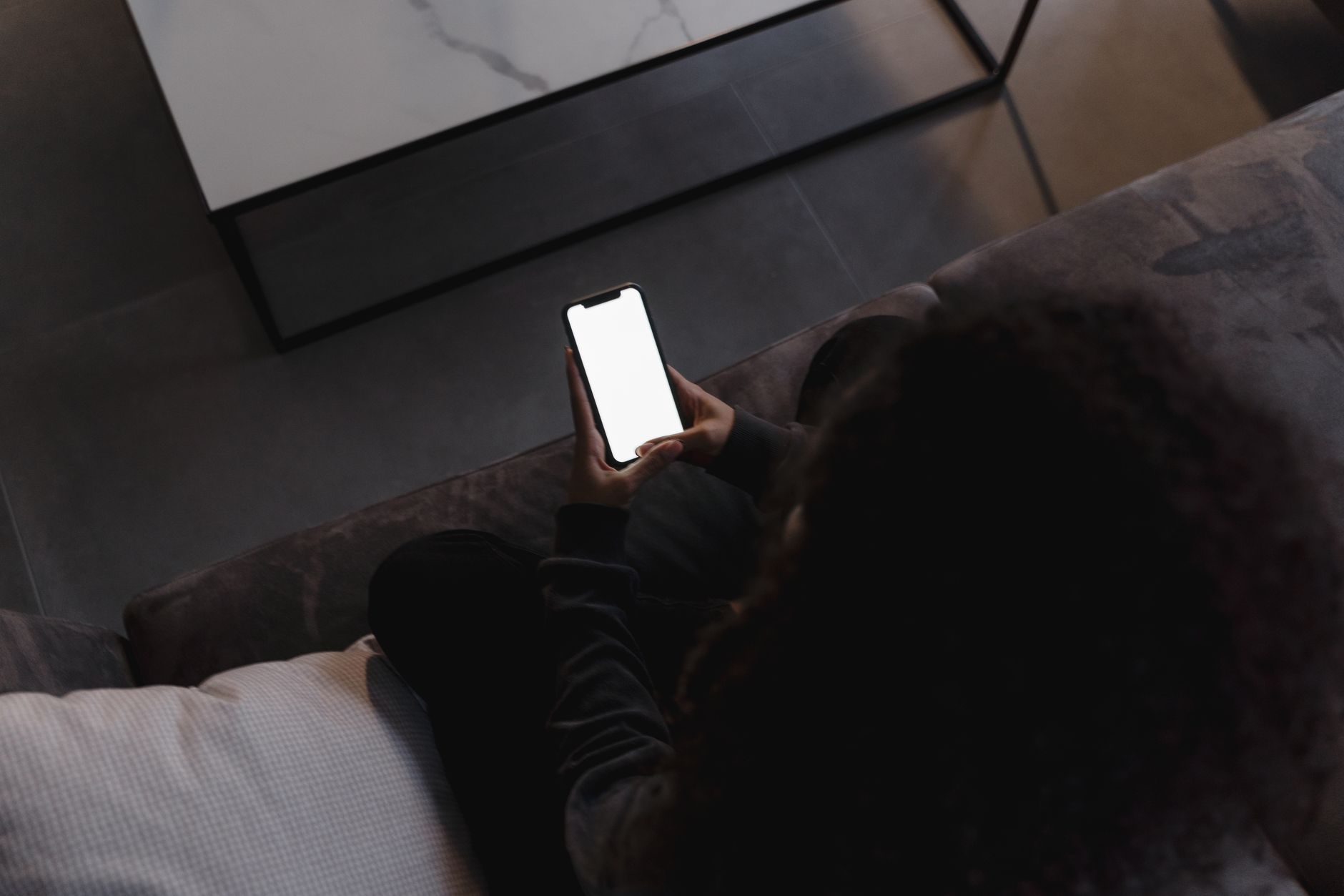 Person using a smartphone to check home internet performance