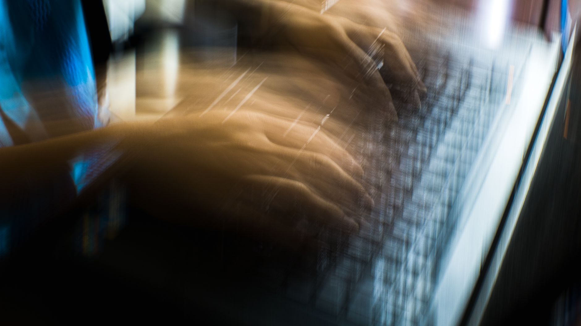Fast-moving hands on a laptop representing internet speed and performance