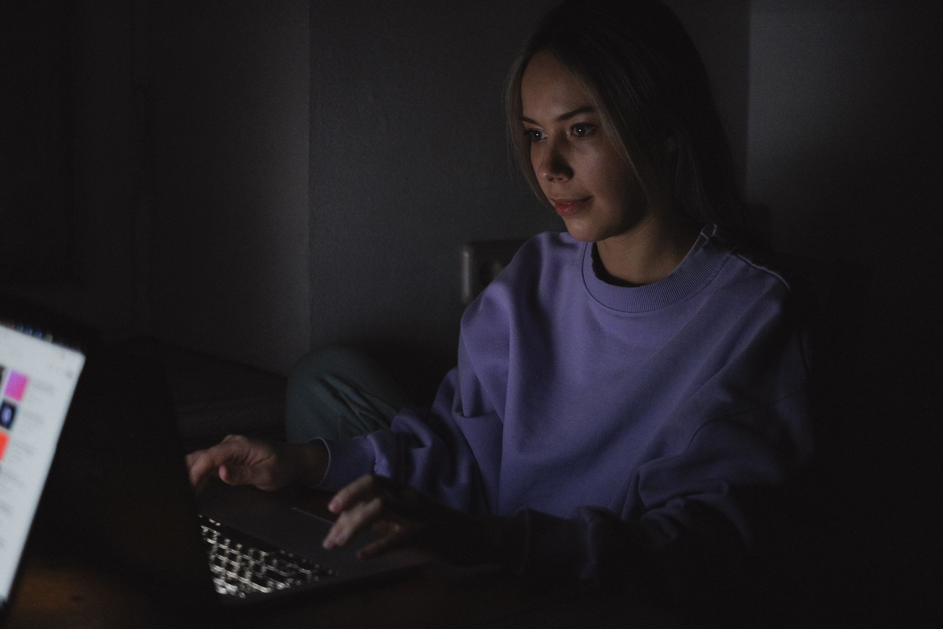 Person using a laptop in the evening