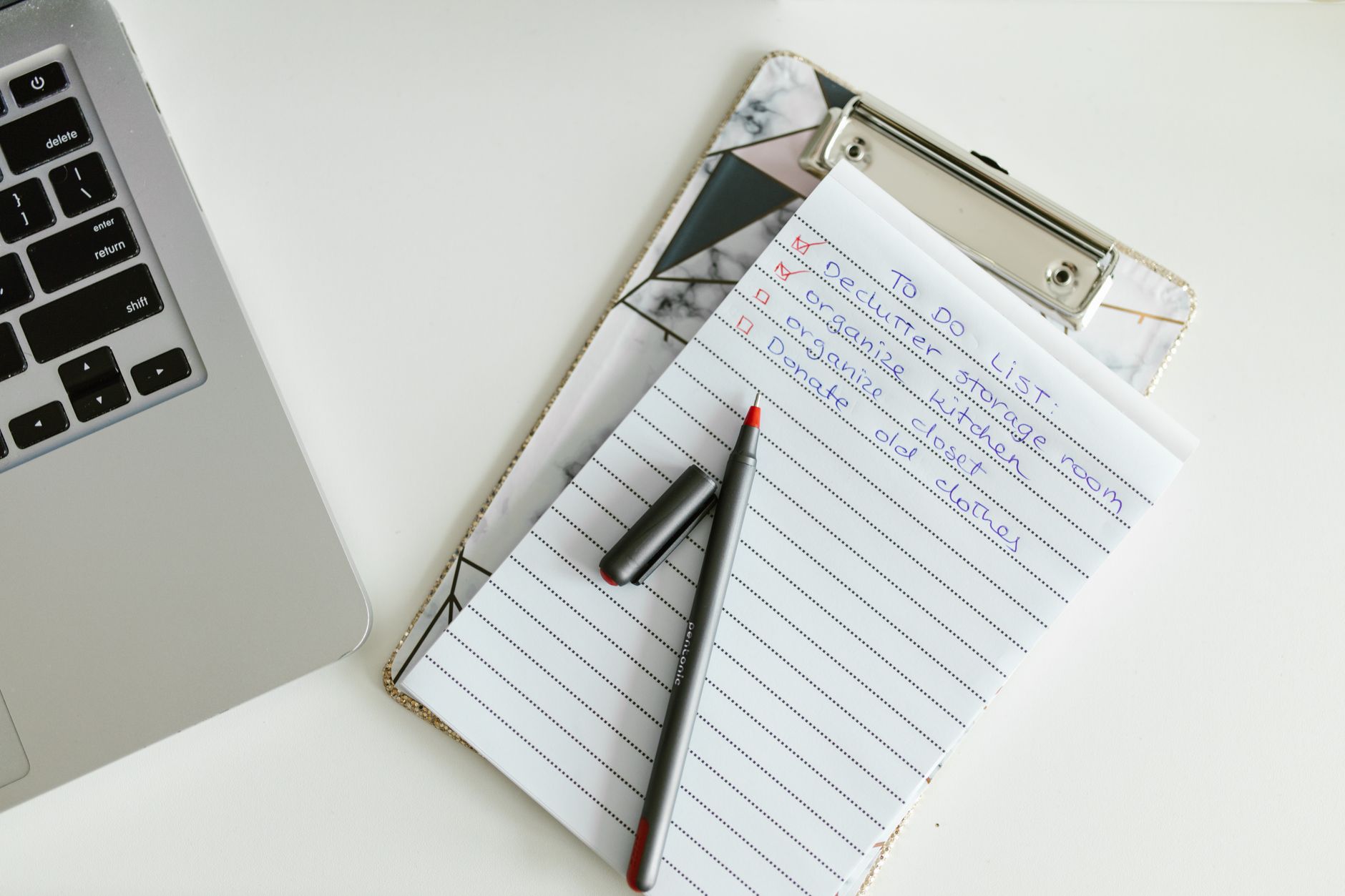 Checklist beside a laptop