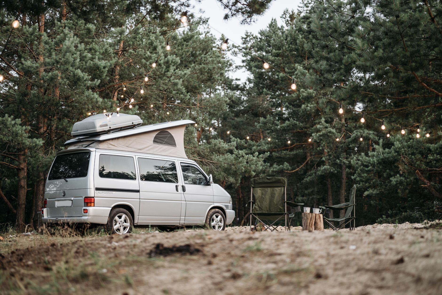 Campervan set up at a forest campsite