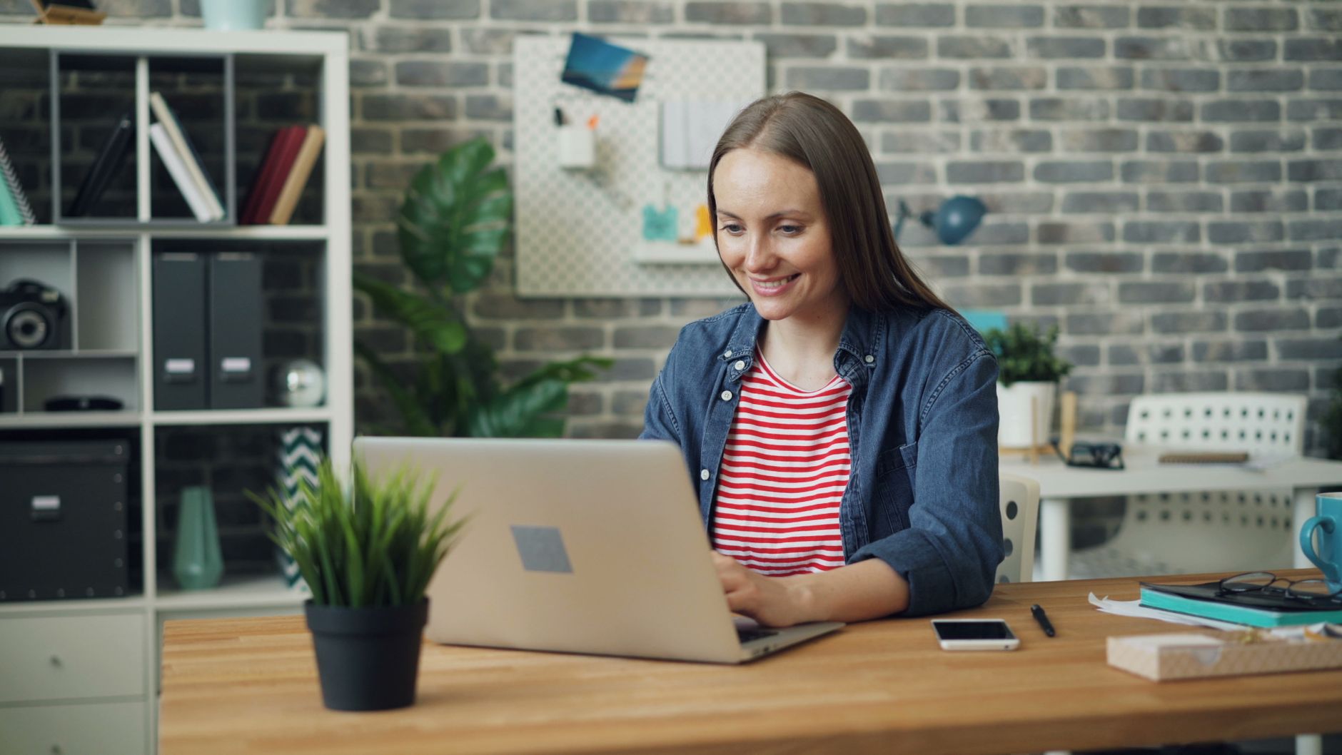 A remote worker using a laptop in a home office with a reliable internet connection.