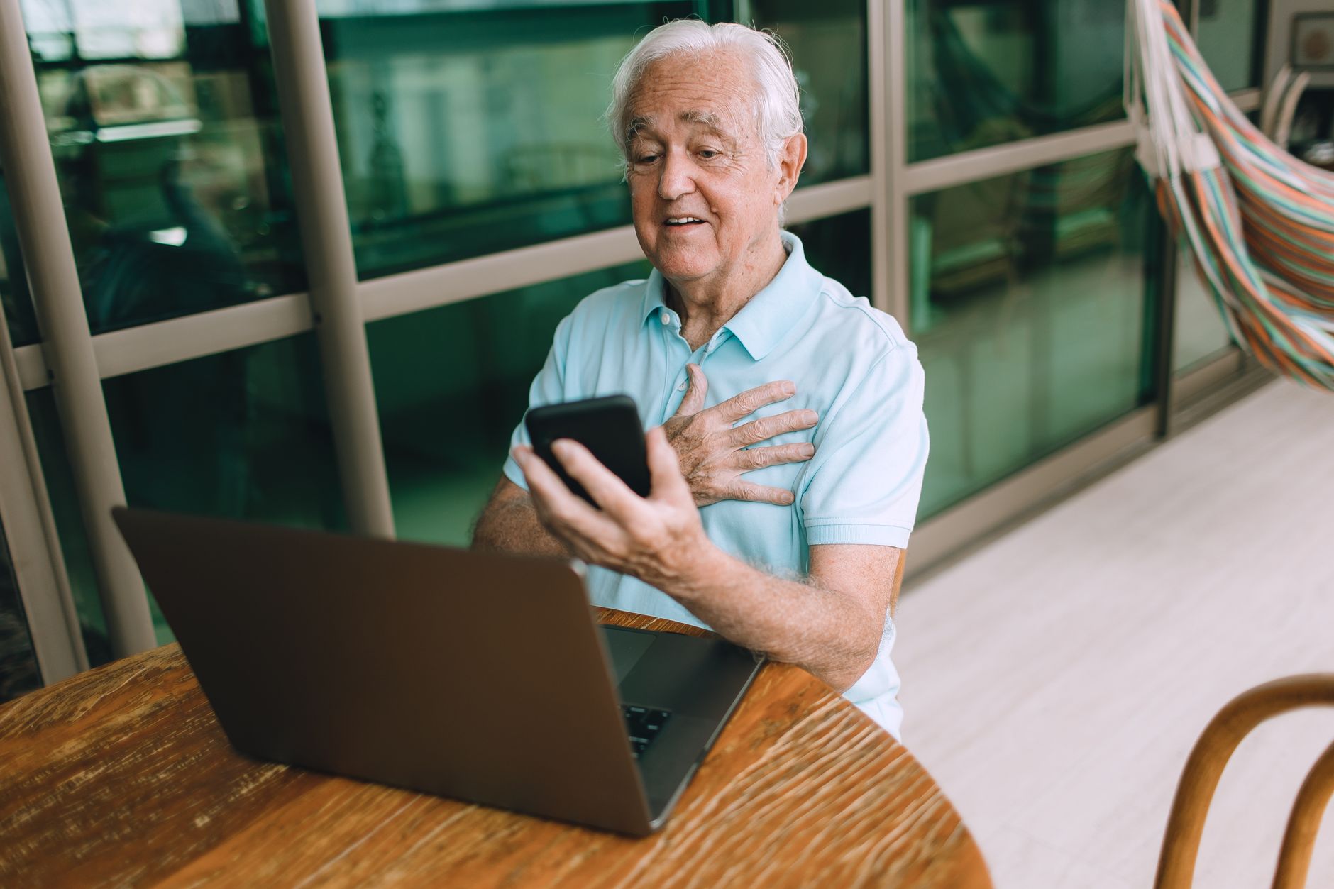 Person using a smartphone and laptop at home while checking a Starlink network