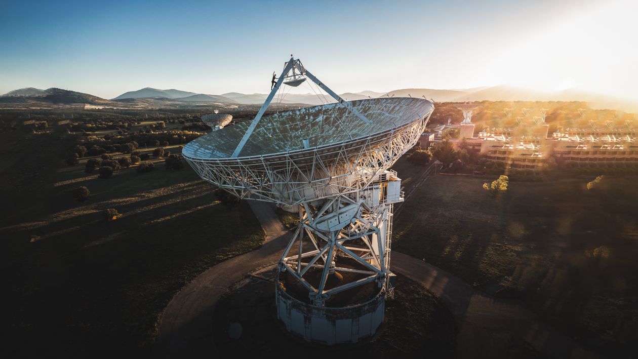 Satellite dish at sunrise in a rural landscape