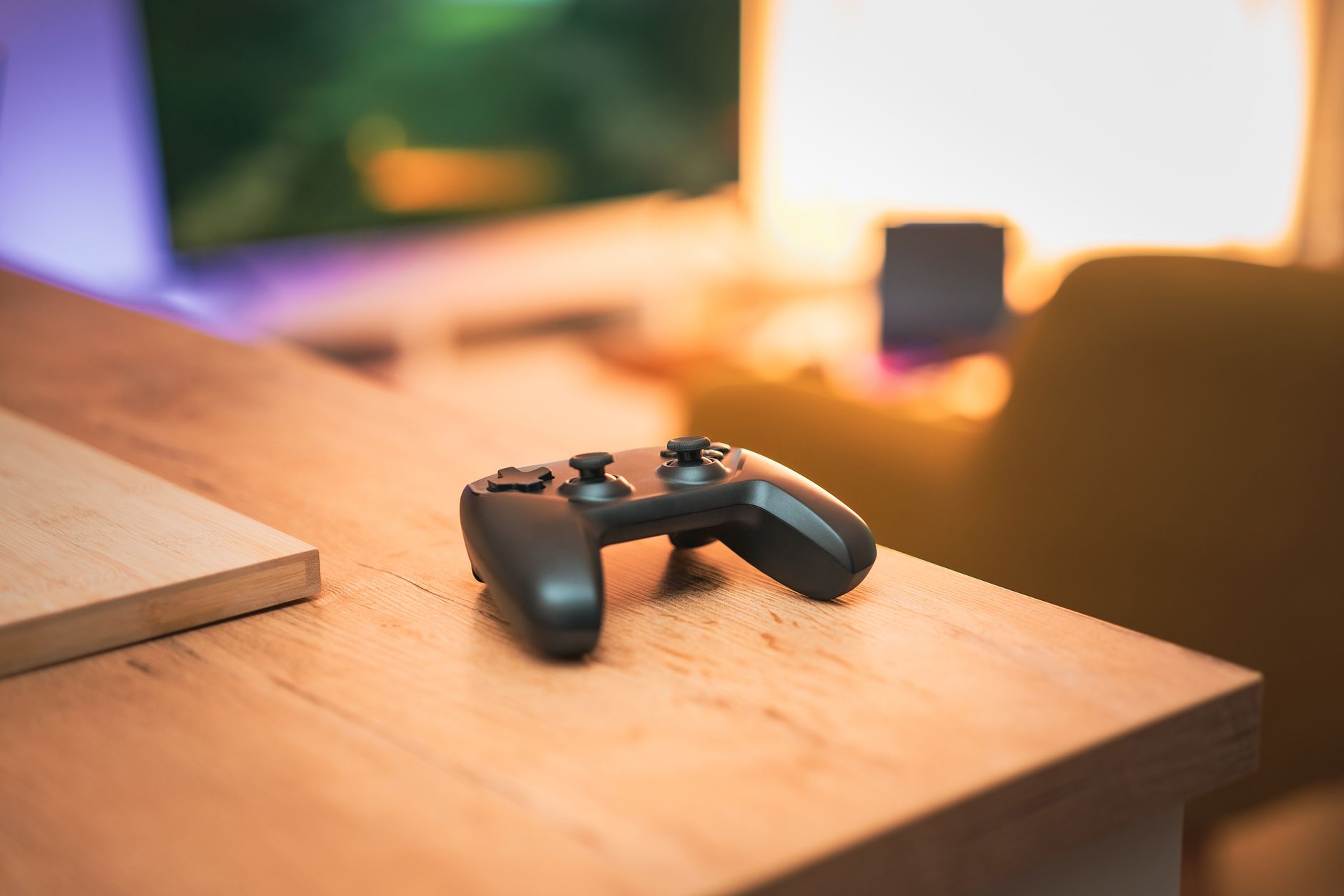 Modern gaming setup with a console controller on a desk