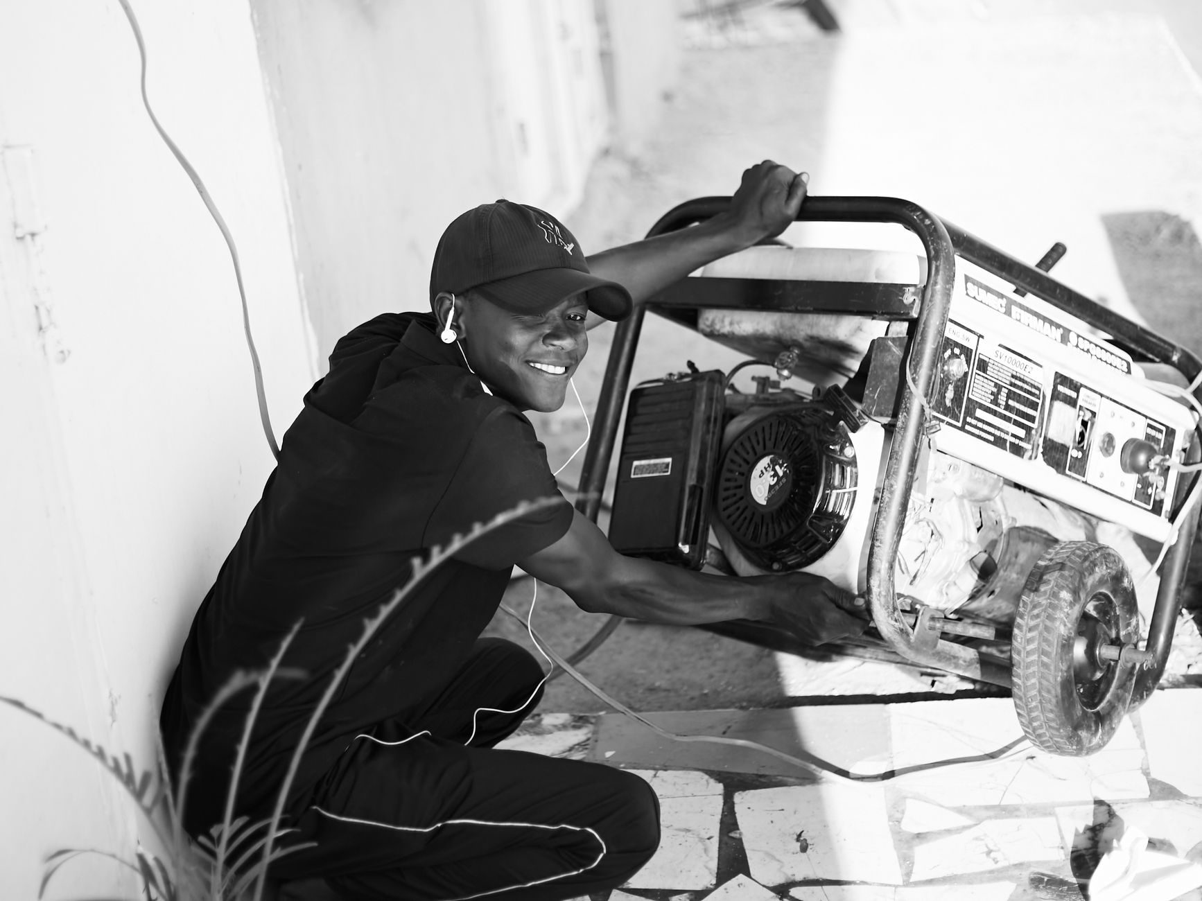 A person operating a portable generator outdoors.