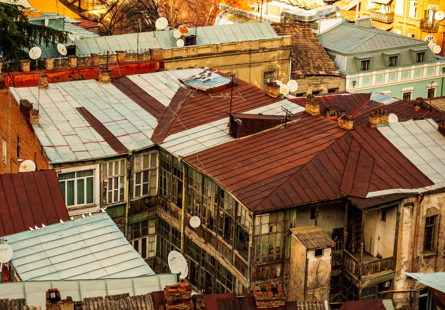 Satellite dishes on rooftops, illustrating a roof-mounted internet installation