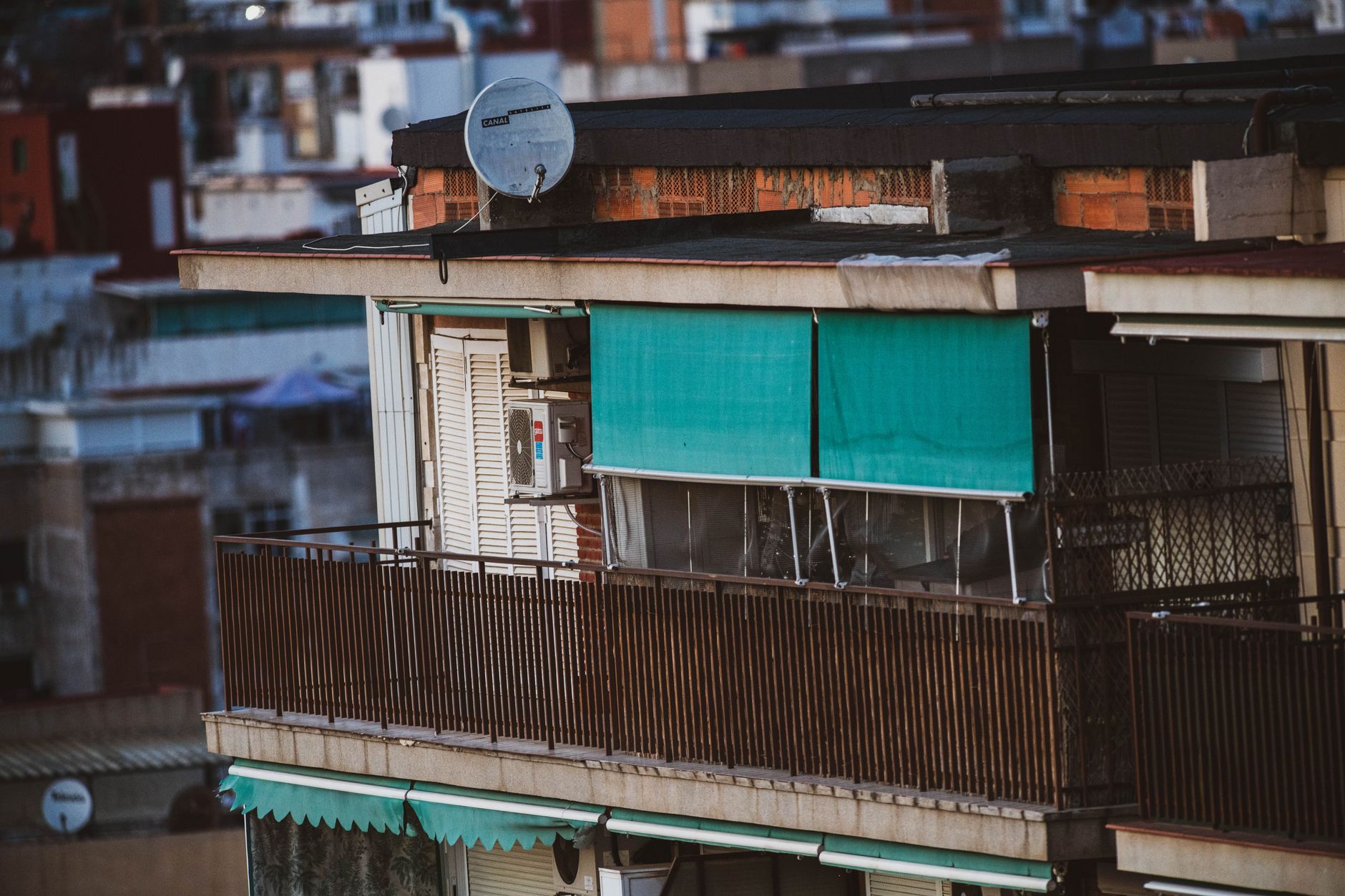 Urban apartment building balcony with a satellite dish
