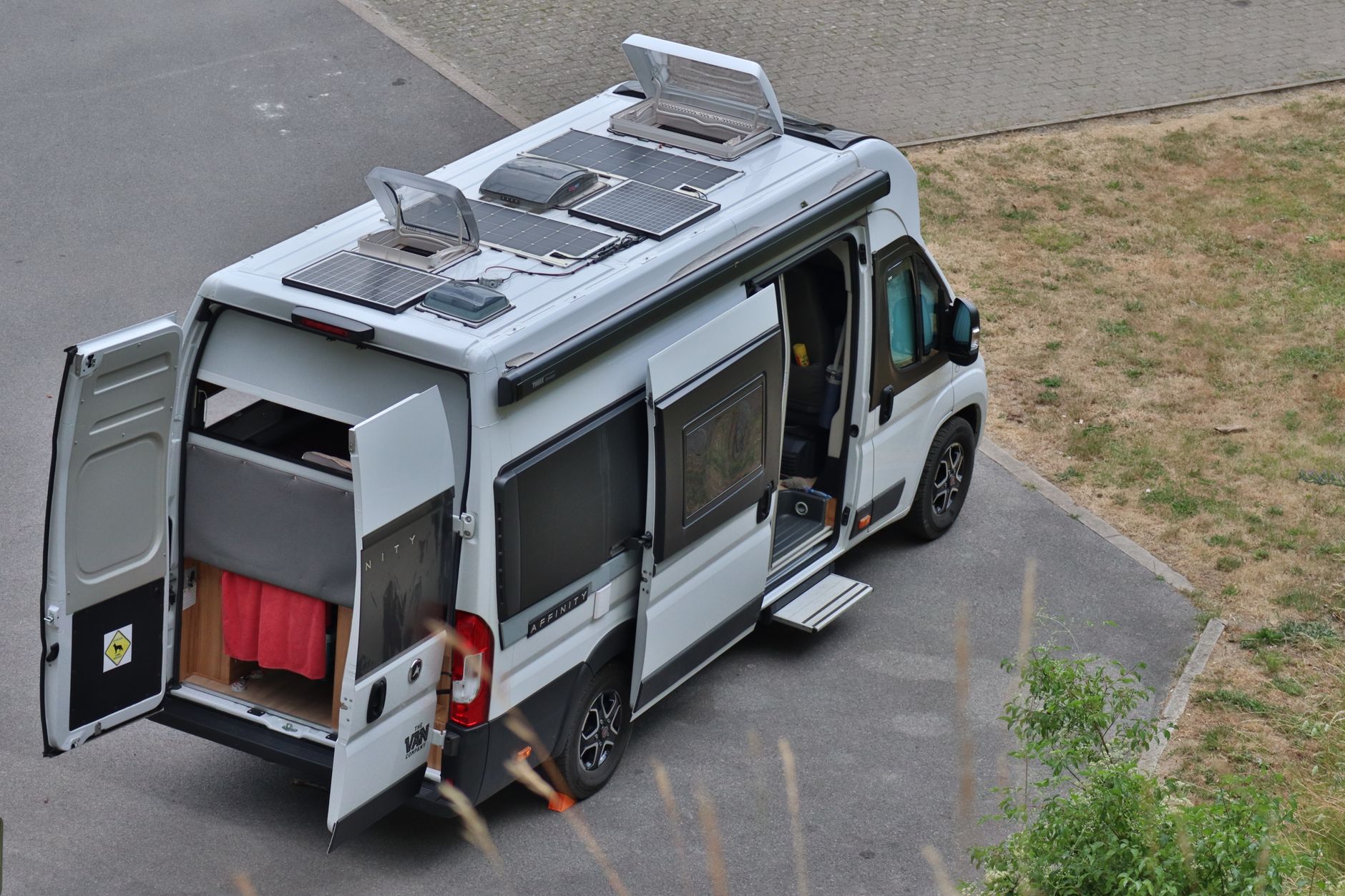 Campervan with solar panels parked outdoors