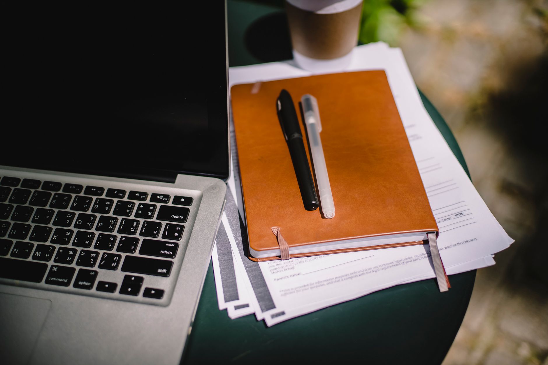 Planning and reviewing information beside a laptop