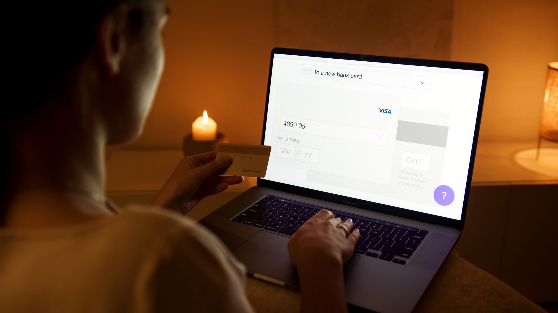 A woman makes a secure online payment using a laptop and credit card.