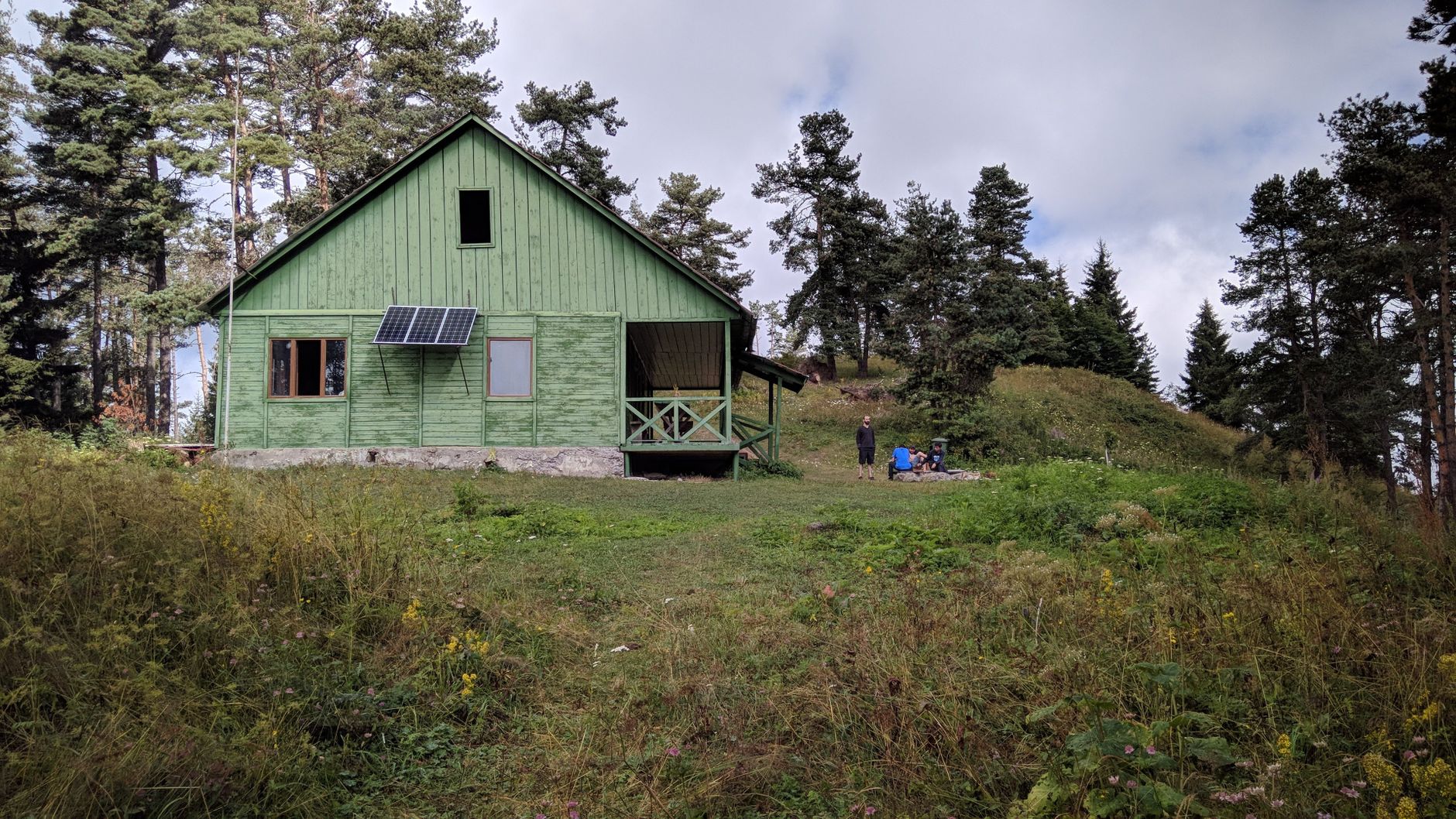 An off-grid rural cabin powered by solar panels for a Starlink solar and battery setup.