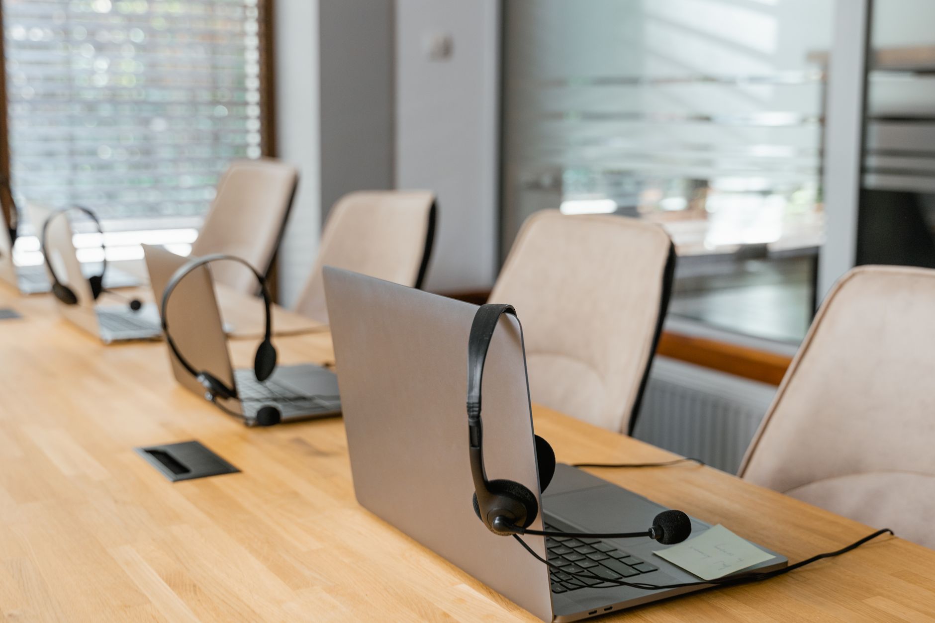 Laptops and headsets set up for internet voice calls in an office