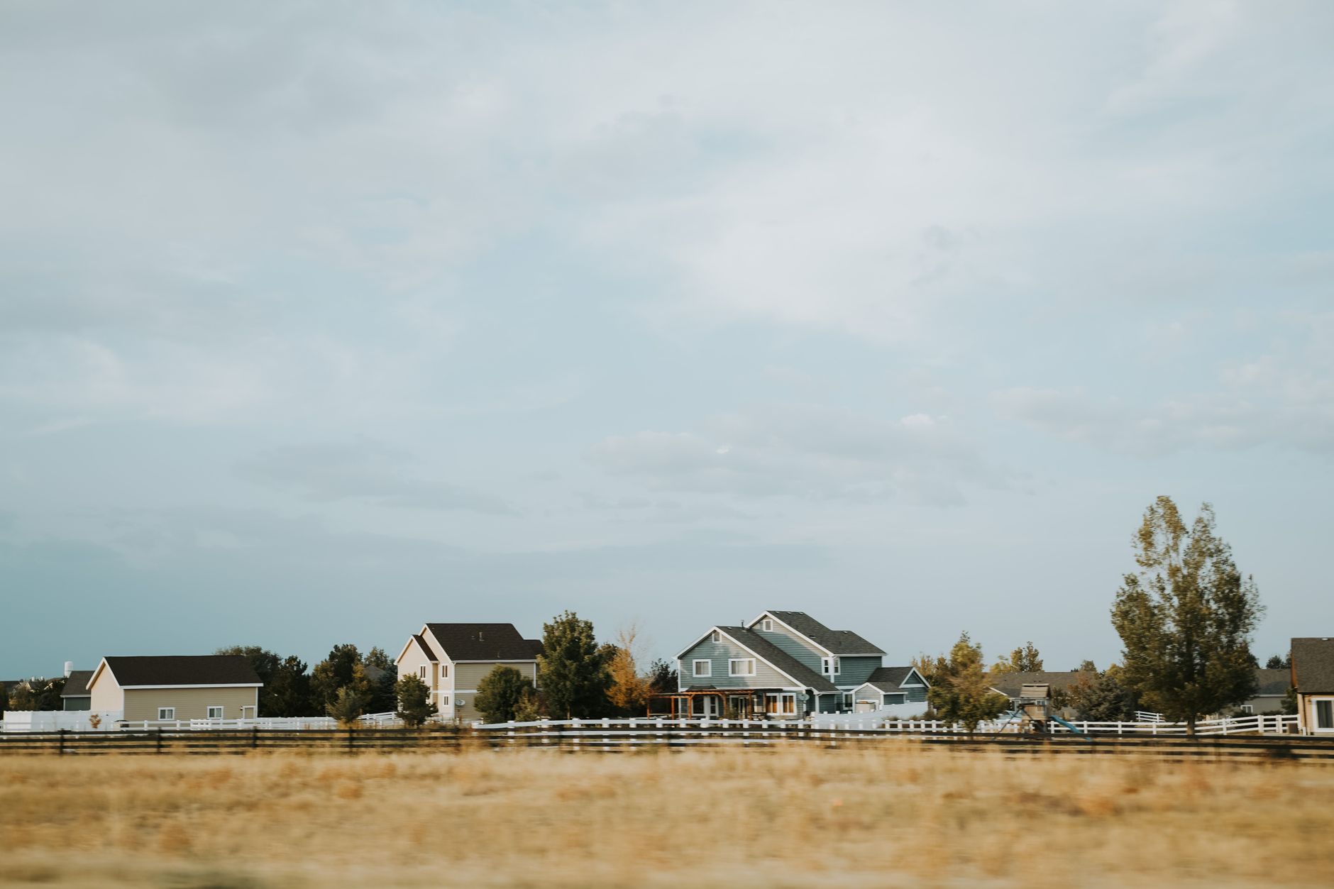 Rural homes in Colorado beneath a wide open sky, illustrating a location where Starlink availability and dish placement should be checked