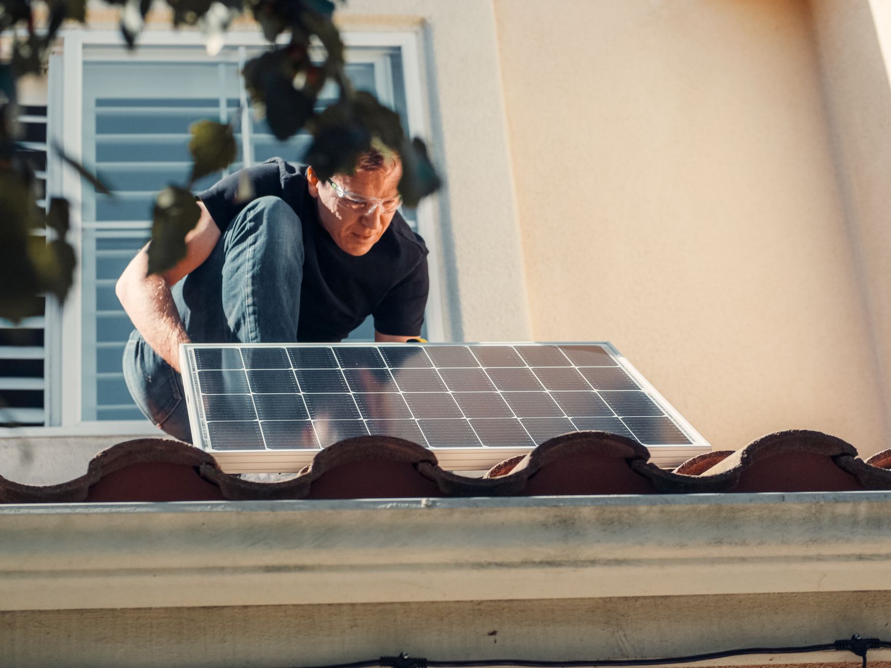 A technician working safely on a rooftop, illustrating roof-mounted Starlink installation.